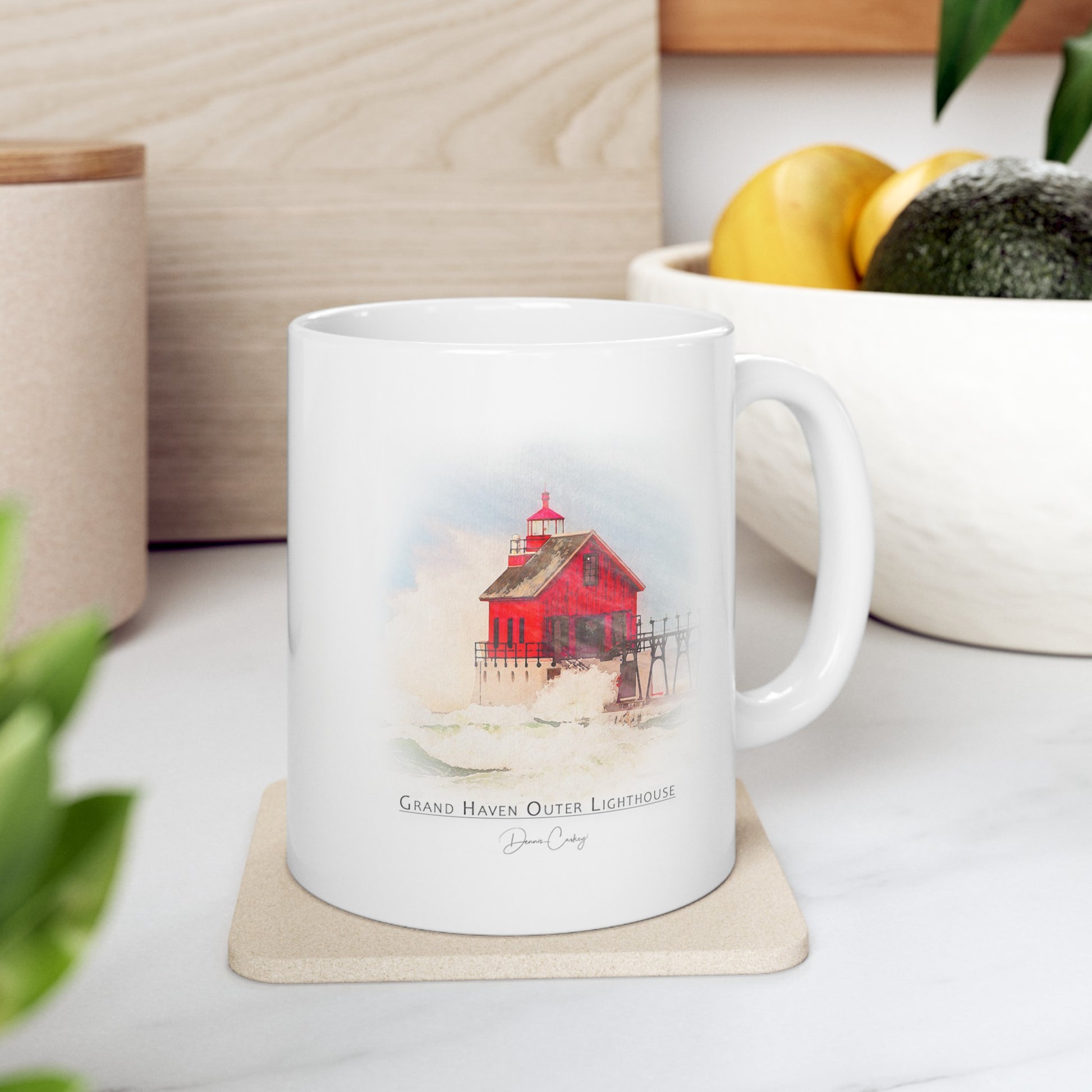 Grand Haven Outer Lighthouse ceramic mug by Dennis Caskey sitting on a desk