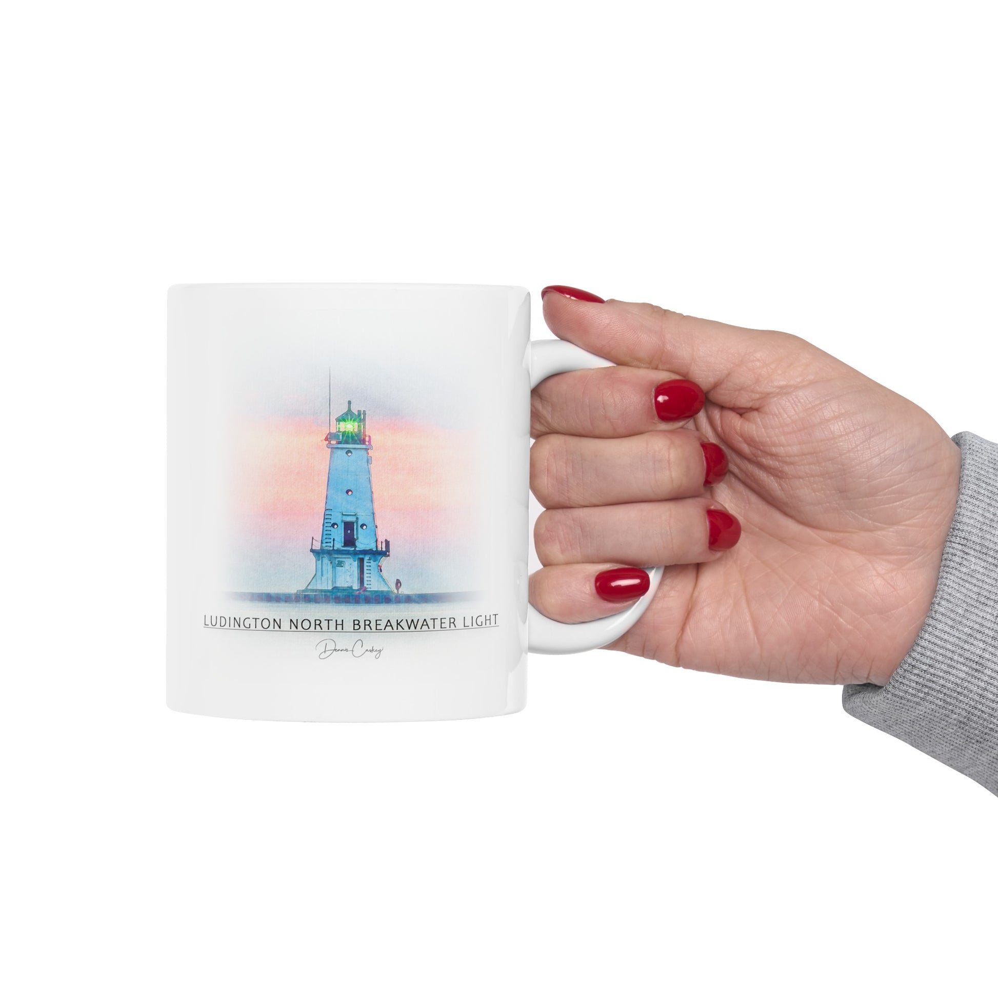 Person holding South Haven Lighthouse ceramic mug by Dennis Caskey