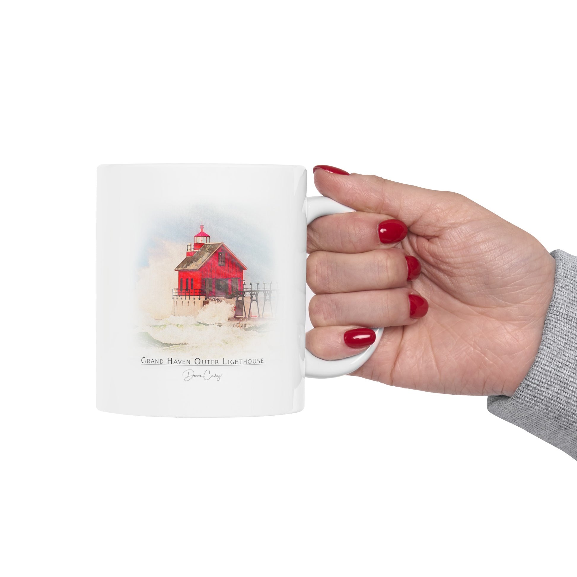 Person holding Grand Haven Outer Lighthouse ceramic mug by Dennis Caskey