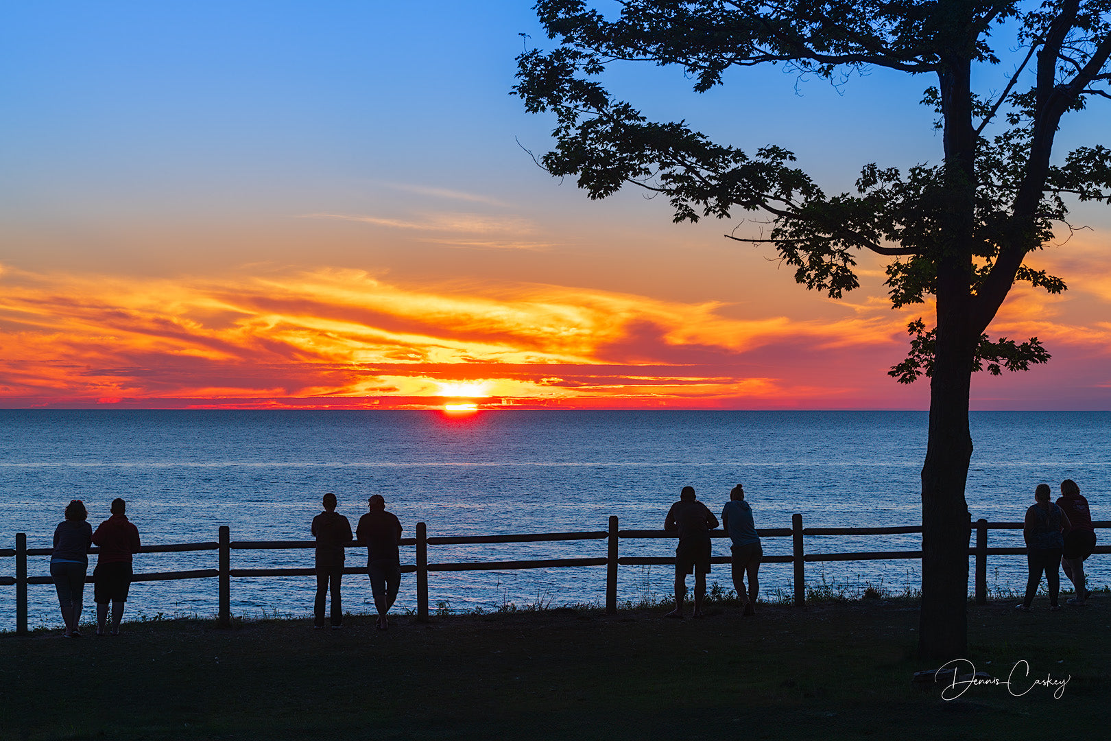 Lake Michigan sunset with people stock photo by Dennis Caskey